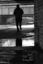 Person running silhouette reflected in puddle Royalty Free Stock Photo