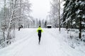 A person running in a snow covered forest. Royalty Free Stock Photo