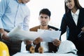 Person's engineer Hand Drawing Plan On Blue Print with architect equipment, Architects discussing at the table. Royalty Free Stock Photo