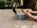 person's hand deftly manipulated both mobile phone and notebook, engaged in the realm of online shopping Royalty Free Stock Photo