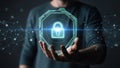 A person\'s hand holding a glowing digital shield with a padlock icon, representing data security and network protection Royalty Free Stock Photo