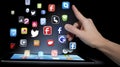 Social media icons fly off the ipad in hand generative ai Royalty Free Stock Photo