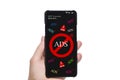 Person`s Hand Holding Mobile Phone With Screen Showing Block Ads Message Against white Background. Stop spam and annoying ad