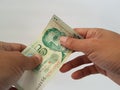 person's hand holding Singapore dollar banknotes