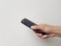 person's hand holding television remote