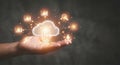 A person\'s hand holds a glowing cloud computing icon surrounded by a network of data analytics and connectivity symbols, Royalty Free Stock Photo