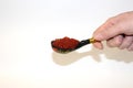 Hand holds wooden spoon full of red caviar Royalty Free Stock Photo