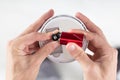 Person`s Hand Inserting Battery In Smoke Detector Royalty Free Stock Photo