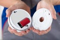 Person`s Hand Inserting Battery In Smoke Detector Royalty Free Stock Photo