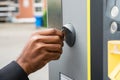 Person`s Hand Inserting Coin Into Parking Meter Royalty Free Stock Photo