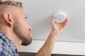 Person`s Hand Installing Smoke Detector On Ceiling Royalty Free Stock Photo