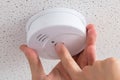 Person's Hand Installing Smoke Detector On Ceiling Royalty Free Stock Photo