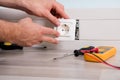 Person`s Hand Installing Socket On Wall Royalty Free Stock Photo