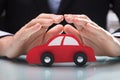 Person`s Hand Protecting Red Car Royalty Free Stock Photo