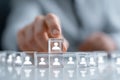 Person selecting transparent cubes with human icons on a modern table Royalty Free Stock Photo