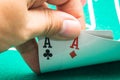 Person's hand showing two aces at a poker game Royalty Free Stock Photo