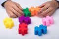 Person`s Hand Solving Jigsaw Puzzle Royalty Free Stock Photo