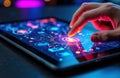 Hand interacts with a futuristic digital interface on a tablet screen displaying Royalty Free Stock Photo