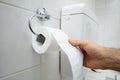 Person`s Hand Using Toilet Paper Royalty Free Stock Photo