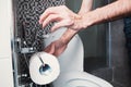 Person`s Hand Using Toilet Paper Royalty Free Stock Photo