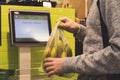 Person`s hand using touch screen monitor panel to buy some food in shop