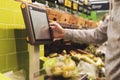 Person`s hand using touch screen monitor panel to buy some food in shop