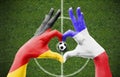 Person`s hands forming a heart with the flags of Germany and France - love towards football concept