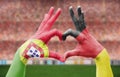 Person`s hands forming heart with the flags of Germany and Portugal - love towards football concept