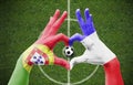 Person`s hands forming a heart with the flags of Portugal and France - love towards football concept