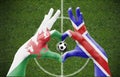 Person`s hands forming a heart with the flags of Wales and Iceland - love towards football concept