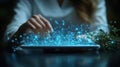 A person\'s hands interacting with a glowing digital interface that emits bright blue particles, suggesting advanced technology an Royalty Free Stock Photo