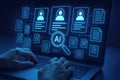 Person typing on laptop displaying AI interface with profiles and documents artificial intelligence Royalty Free Stock Photo