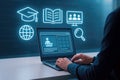 Person using laptop with glowing online education icons and interface computer online learning Royalty Free Stock Photo