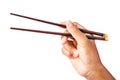 Person `s right hand using bamboo chopsticks.