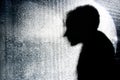 Person's silhouette behind glass wall Royalty Free Stock Photo
