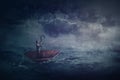 Person sailing alone the ocean on an umbrella boat, looking for shore. Surreal scene with a storm over the sea. Fantastic Royalty Free Stock Photo