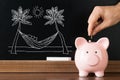 Person Saving Money In Piggybank For Vacation Royalty Free Stock Photo