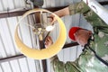 Person screws chandelier to ceiling of garage