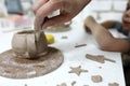 Person sculpts clay cup