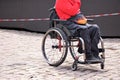 Person seated in ergonomic wheelchair with flame design fanny pack Royalty Free Stock Photo