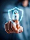 A person securing digital data by interacting with a glowing shield and lock hologram symbolizing advanced cybersecurity and Royalty Free Stock Photo