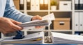 Person organizing documents in an office setting Royalty Free Stock Photo
