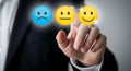 A person selecting a smiley face on a digital interface representing customer satisfaction. Royalty Free Stock Photo