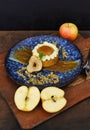 Person serving Apple tart with fresh apples on wooden table