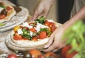 Person serving a homemade pizza