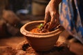 a person serving lahpa in a rustic clay pot