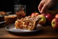 person serving a slice of apple pie