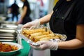 person serving spring rolls at a healthcare charity food event