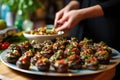 person serving stuffed mushrooms at a party