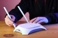 Person setting internet router antennas on wooden table